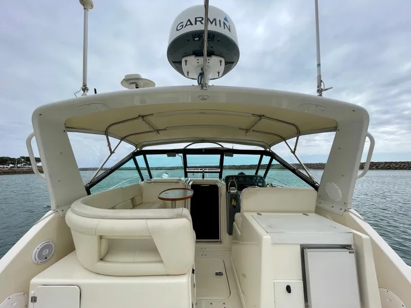 Slide: The Image of 1998 Tiara Yachts 3100 Open boat interior with Garmin equipment, docked on calm water. - 18