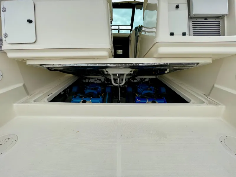 Slide: The Image of 1998 Tiara Yachts 3100 Open engine compartment, showcasing dual engines and spacious design. - 29