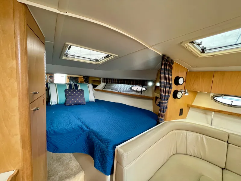 Slide: The Image of Interior of 1998 Tiara Yachts 3100 Open with cozy bed and seating area. - 48