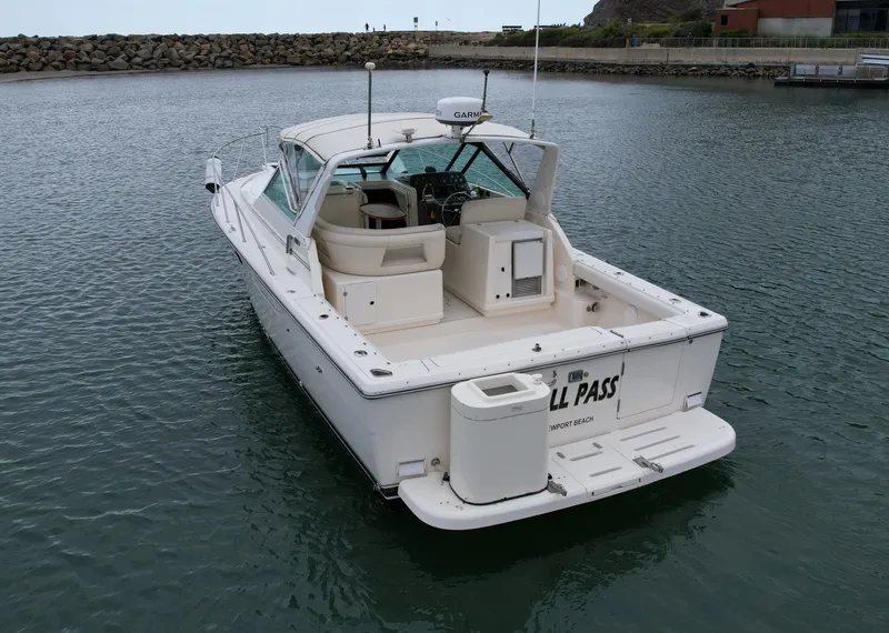 Slide: The Image of 1998 Tiara Yachts 3100 Open boat docked in calm waters, rear view. - 5