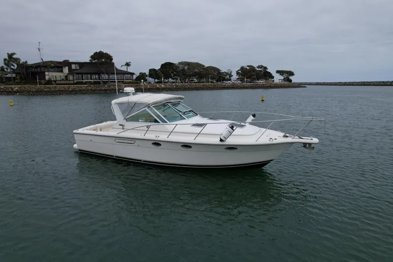 Slide: The Image of 1998 Tiara Yachts 3100 Open cruising in calm waters near a coastal area. - 6