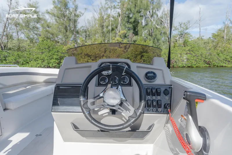 Slide: The Image of 2023 Starcraft SVX 191 OB boat dashboard with steering wheel and controls. - 7