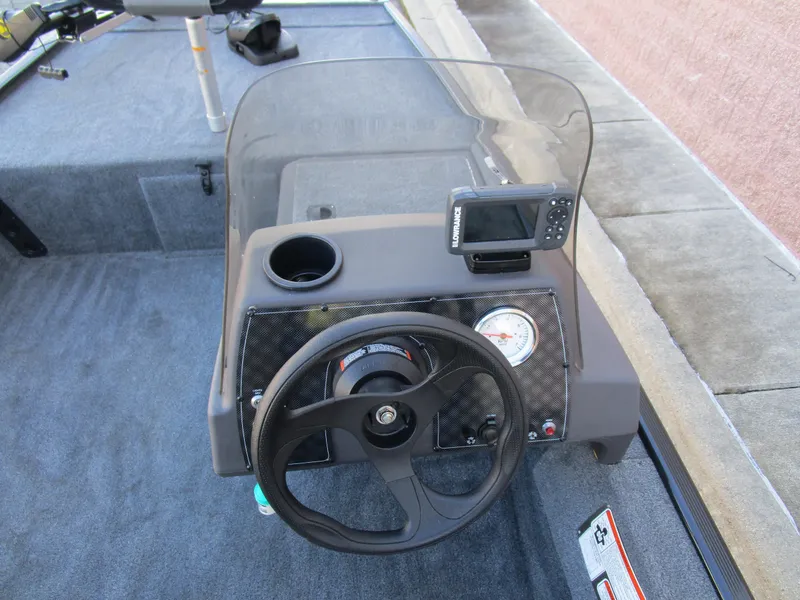Slide: The Image of 2023 Tracker Bass Tracker Classic XL boat dashboard with steering wheel and fish finder. - 20