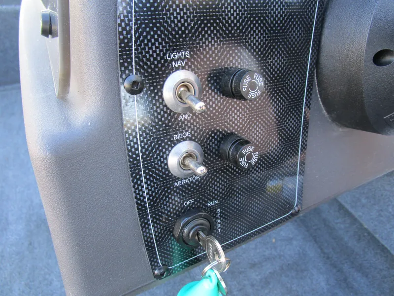 Slide: The Image of Control panel of 2023 Tracker Bass Tracker Classic XL boat with switches and ignition. - 22