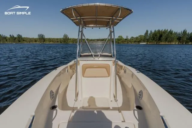 Slide: The Image of 2022 Scout 195 Sportfish boat on a serene lake. - 6