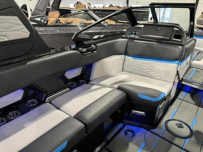 Slide: The Image of 2025 Supra SA boat interior with modern seating and blue accent lighting. - 10
