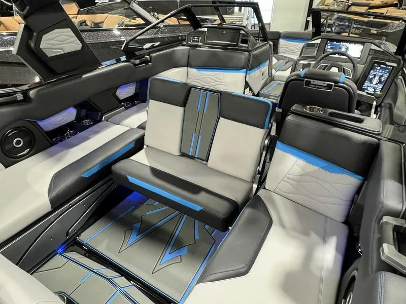 Slide: The Image of 2025 Supra SA boat interior with modern seating, blue accents, and advanced dashboard technology. - 16