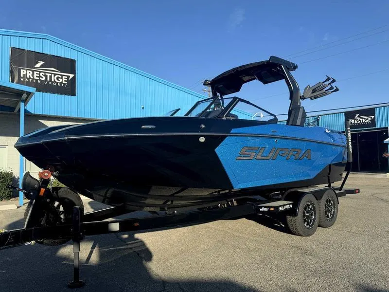Slide: The Image of 2025 Supra SA boat in blue and black, displayed at Prestige Water Sports. - 3