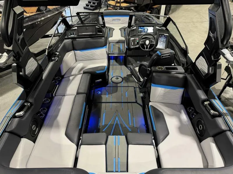 Slide: The Image of 2025 Supra SA boat interior with modern design, blue LED lighting, and luxurious seating. - 9