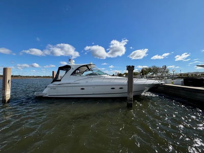 Slide: The Image of 2005 Cruisers Yachts 440 Express docked on a sunny day with blue skies. - 1