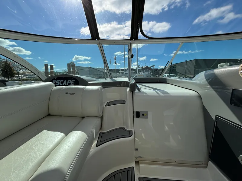 Slide: The Image of 2005 Cruisers Yachts 440 Express interior with white seating and clear sky view. - 13