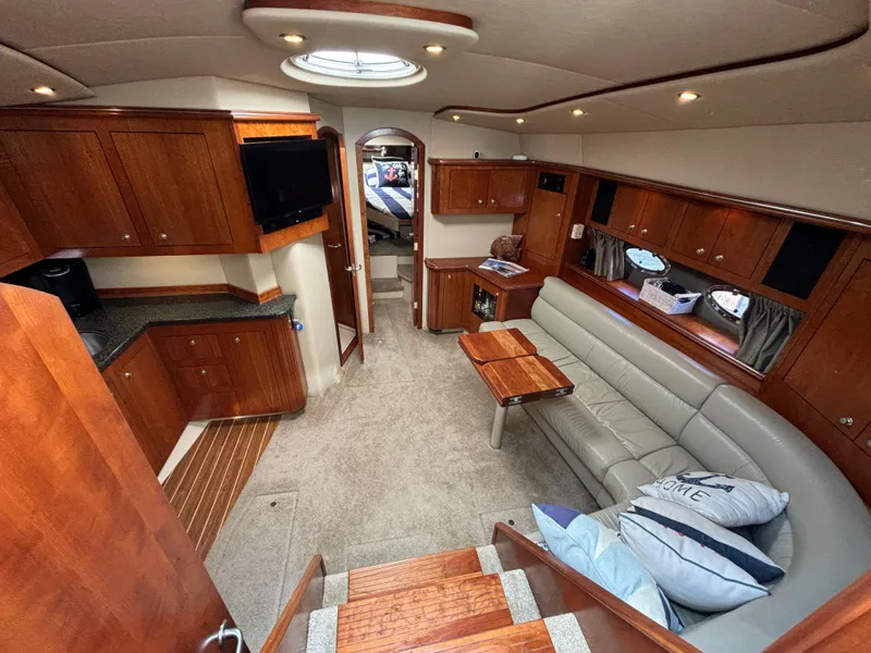 Slide: The Image of Luxurious 2005 Cruisers Yachts 440 Express interior with elegant wood finishes and comfortable seating. - 18