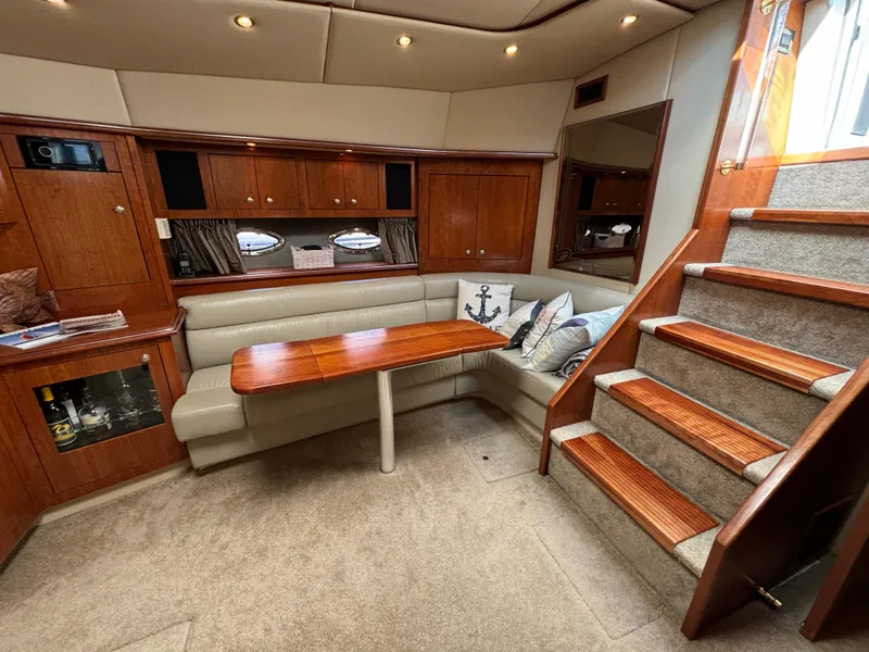 Slide: The Image of Luxurious interior of 2005 Cruisers Yachts 440 Express with wooden table and stairs. - 19