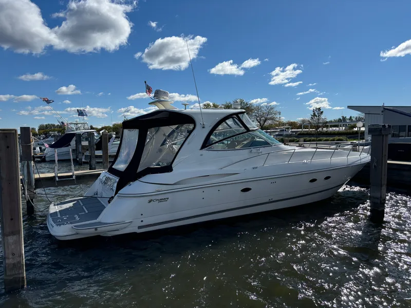 Slide: The Image of 2005 Cruisers Yachts 440 Express docked under a clear blue sky. - 2