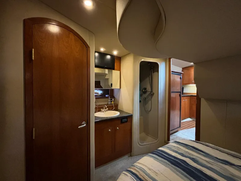 Slide: The Image of 2005 Cruisers Yachts 440 Express interior with bathroom, shower, and cozy cabin. - 24