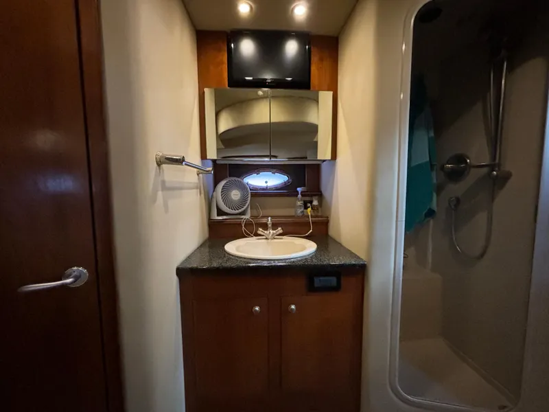 Slide: The Image of 2005 Cruisers Yachts 440 Express bathroom with sink, mirror, and shower. - 25