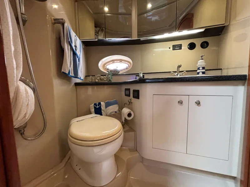 Slide: The Image of Bathroom interior of 2005 Cruisers Yachts 440 Express, featuring modern fixtures and cabinetry. - 29