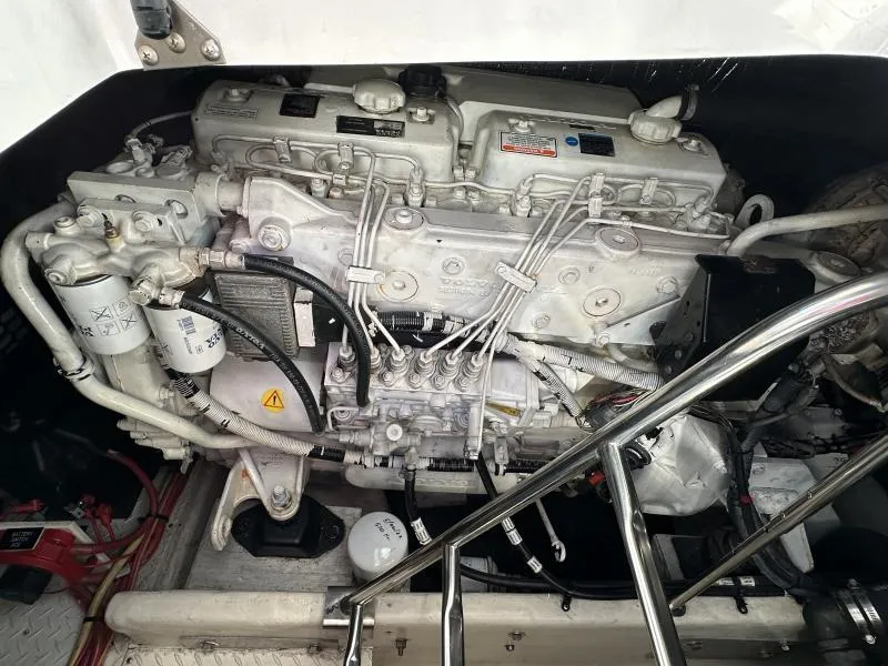 Slide: The Image of Engine compartment of a 2005 Cruisers Yachts 440 Express, showcasing detailed mechanical components. - 34