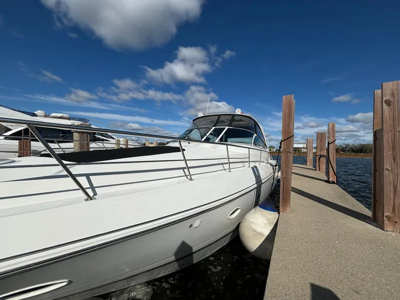 Slide: The Image of 2005 Cruisers Yachts 440 Express docked under a clear blue sky. - 4