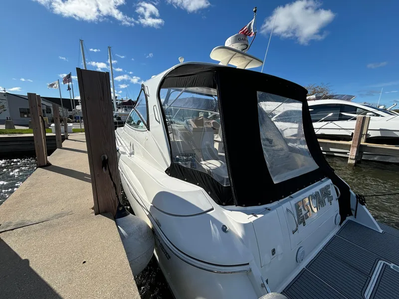 Slide: The Image of 2005 Cruisers Yachts 440 Express docked at marina under clear blue sky. - 5