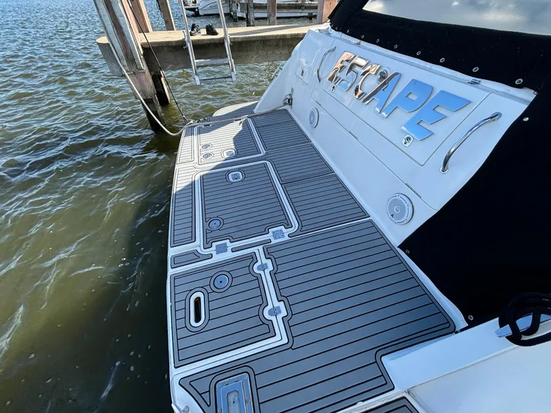 Slide: The Image of 2005 Cruisers Yachts 440 Express boat docked, featuring a sleek swim platform. - 6
