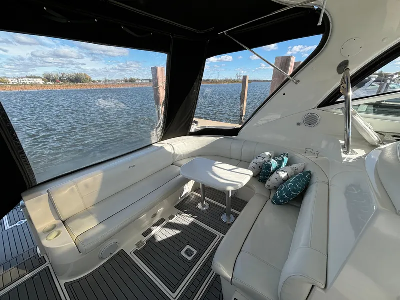 Slide: The Image of 2005 Cruisers Yachts 440 Express interior with plush seating and scenic water view. - 8