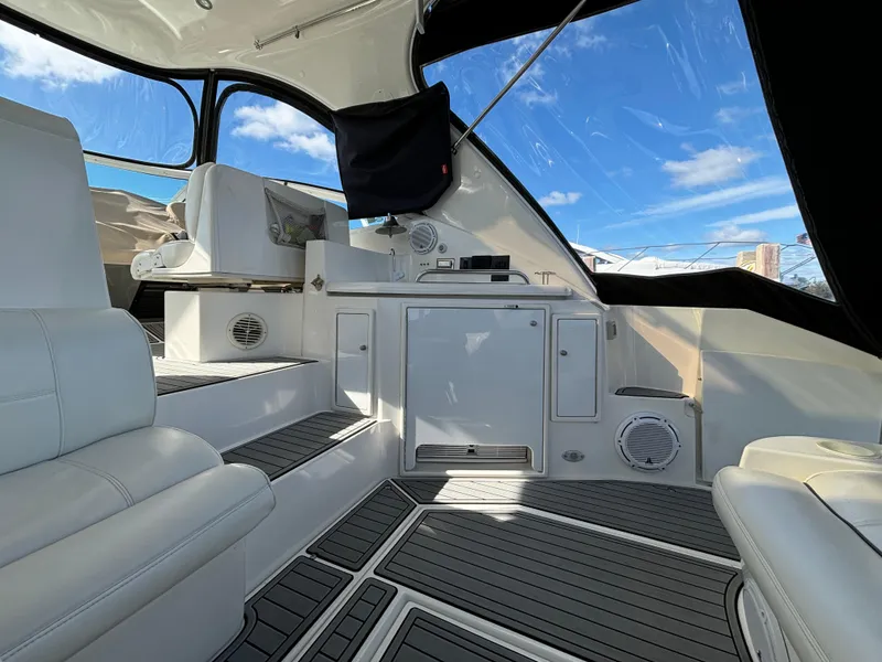 Slide: The Image of 2005 Cruisers Yachts 440 Express interior with white seating and modern design. - 9