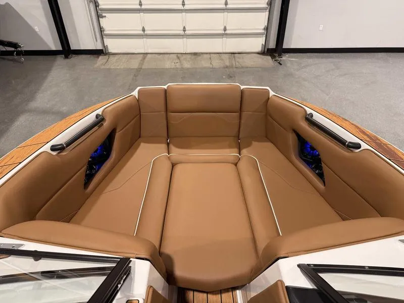 Slide: The Image of 2025 Moomba Mojo boat interior with tan seating and modern design. - 11