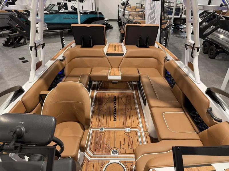 Slide: The Image of 2025 Moomba Mojo boat interior with tan seating and wood accents. - 12