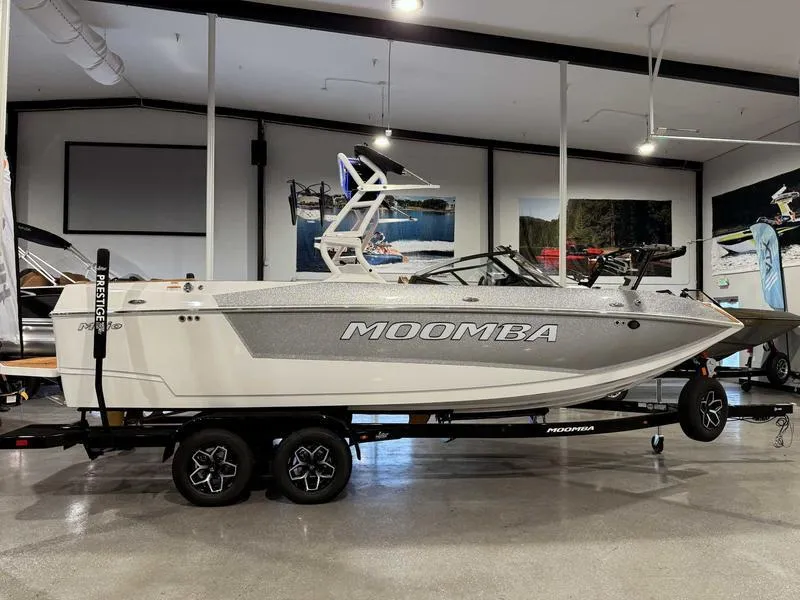 Slide: The Image of 2025 Moomba Mojo boat displayed indoors on a trailer. - 13