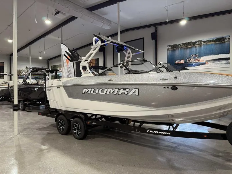 Slide: The Image of 2025 Moomba Mojo boat displayed in a showroom, featuring sleek design and modern features. - 14
