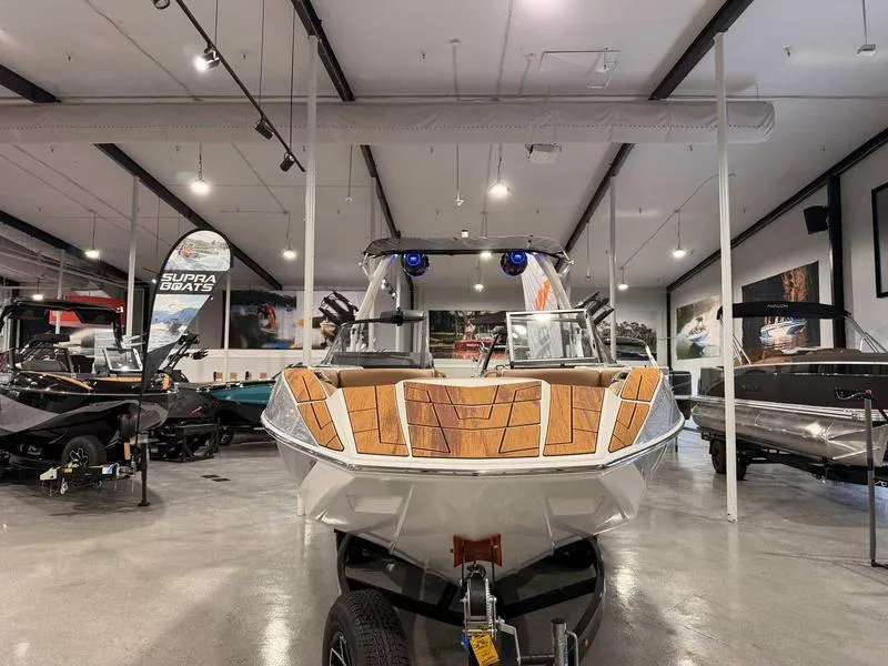 Slide: The Image of 2025 Moomba Mojo boat displayed in a showroom with modern interior and lighting. - 15