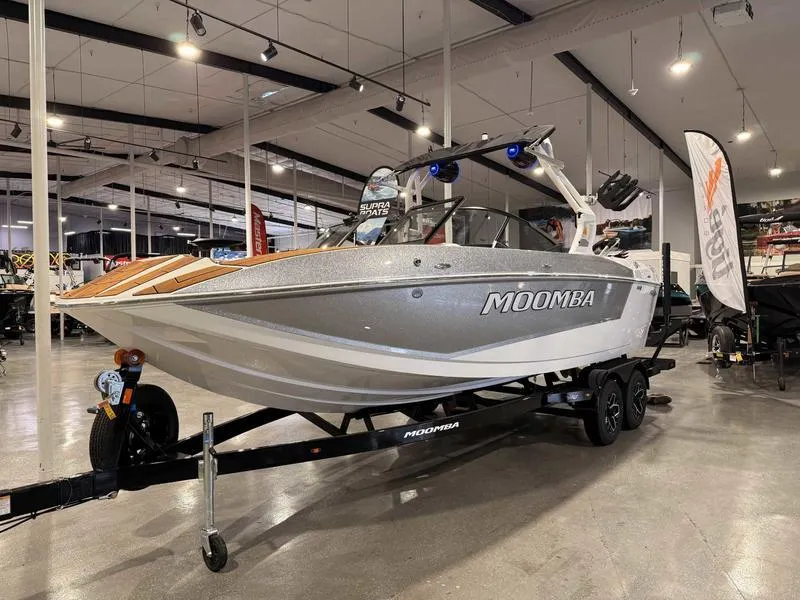 Slide: The Image of 2025 Moomba Mojo boat displayed in a showroom on a trailer. - 16