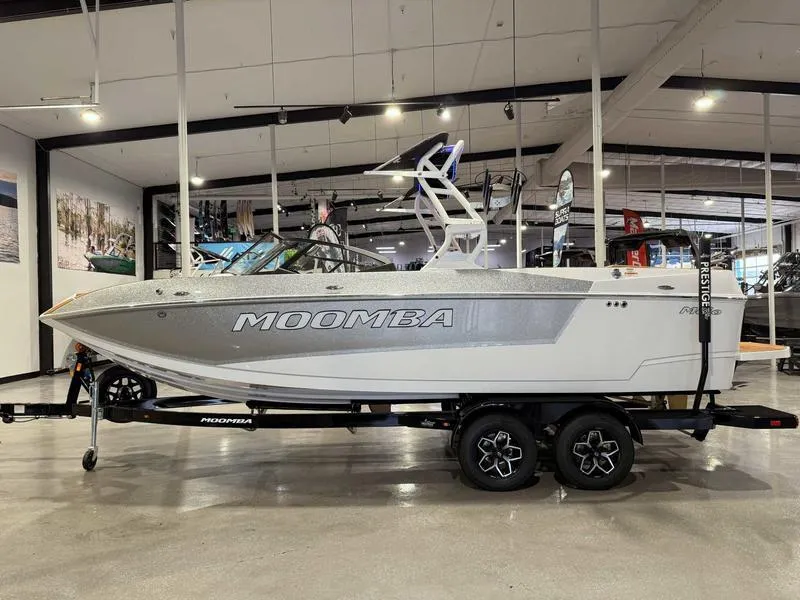 Slide: The Image of 2025 Moomba Mojo boat on trailer in showroom, side view. - 17