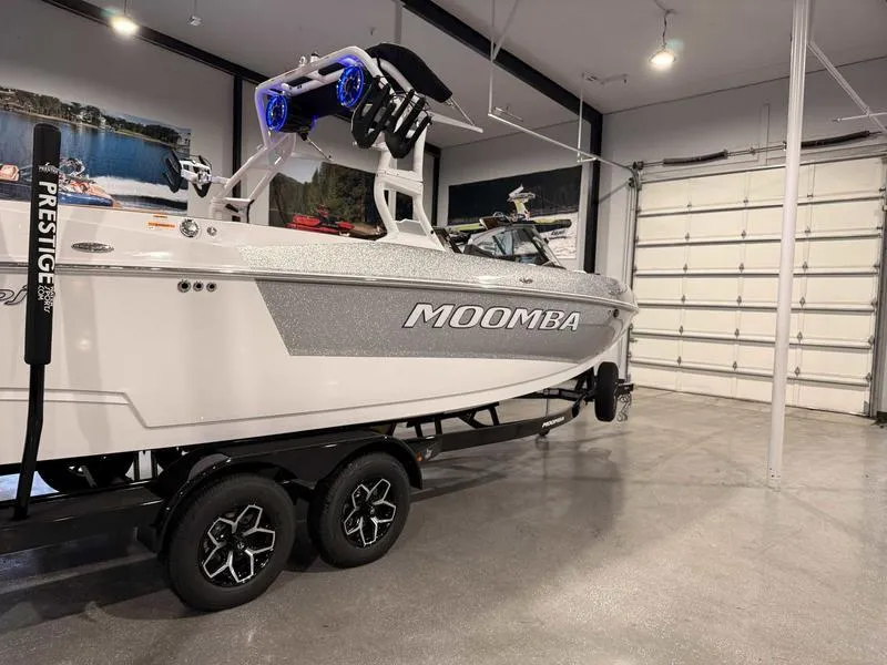 Slide: The Image of 2025 Moomba Mojo boat on trailer in a spacious garage setting. - 20