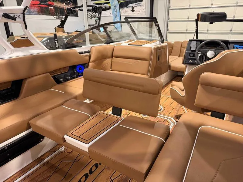 Slide: The Image of 2025 Moomba Mojo boat interior with tan leather seating and modern dashboard. - 8