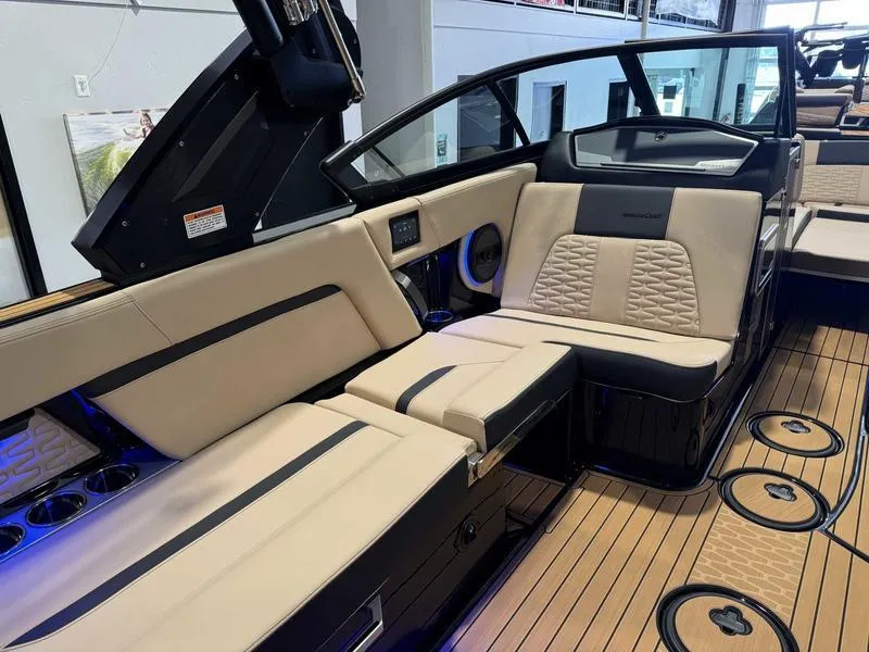 Slide: The Image of 2025 MasterCraft X24 boat interior with beige seating and teak flooring. - 10
