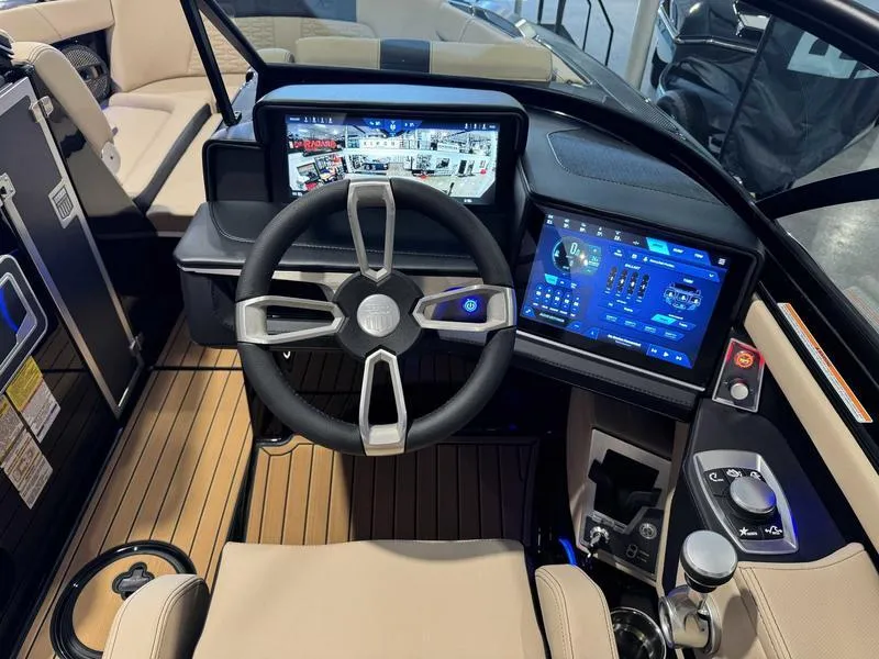 Slide: The Image of 2025 MasterCraft X24 boat cockpit with advanced digital displays and modern steering wheel. - 11