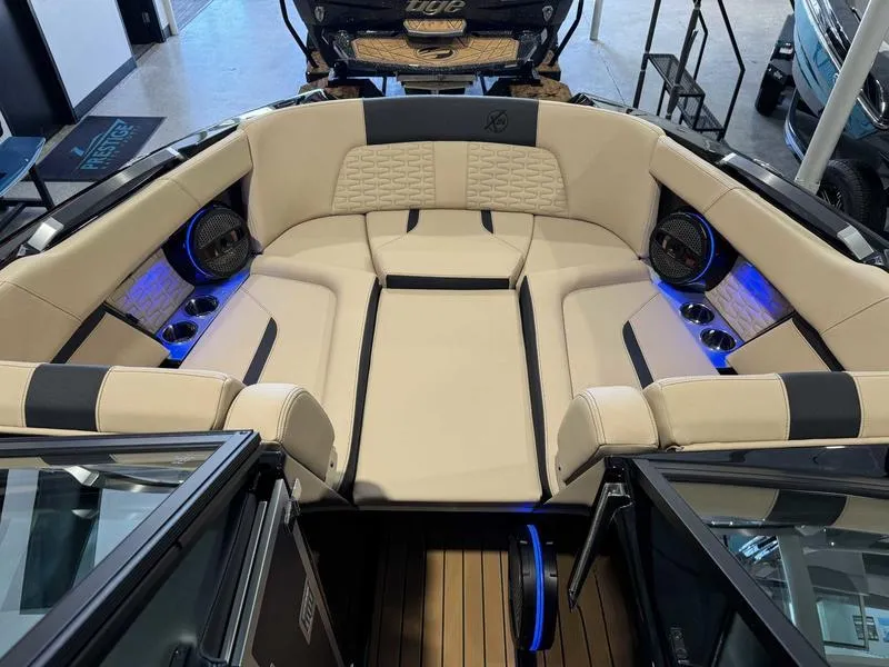 Slide: The Image of Luxurious interior of 2025 MasterCraft X24 boat with beige seating and blue LED lighting. - 12