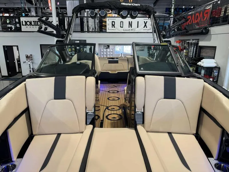 Slide: The Image of 2025 MasterCraft X24 boat interior with beige seating and modern design. - 13