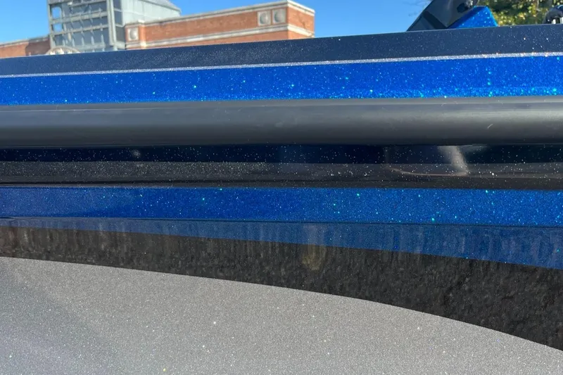 Slide: The Image of Close-up of a 2025 Nitro Z19 boat with a blue metallic finish. - 11