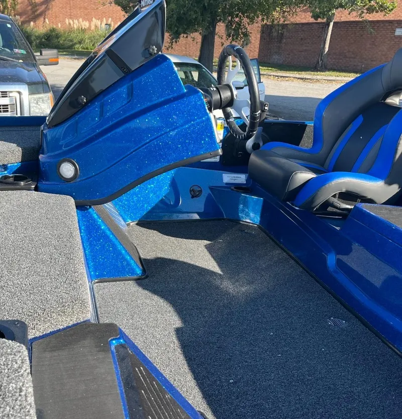 Slide: The Image of 2025 Nitro Z19 boat interior with blue console and seating. - 12