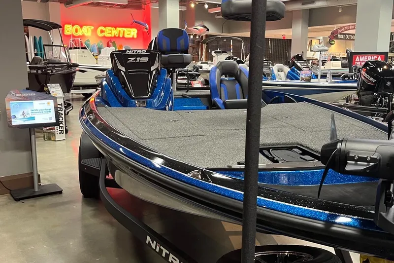 Slide: The Image of 2025 Nitro Z19 boat displayed at a boat center showroom. - 2