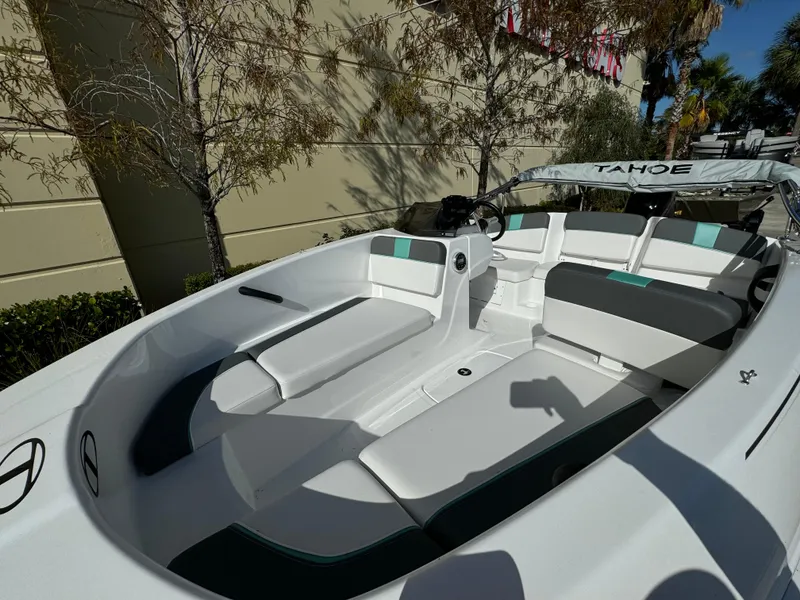 Slide: The Image of 2025 Tahoe T16 boat interior with white and gray seating, outdoor setting. - 3