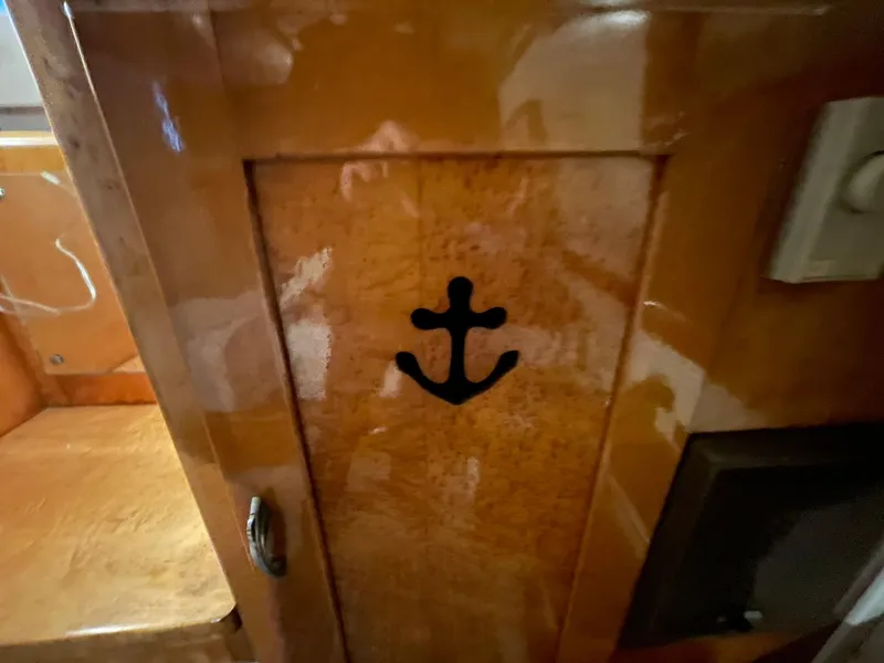 Slide: The Image of 1951 Chris-Craft Catalina wooden interior with anchor design on cabinet door. - 15