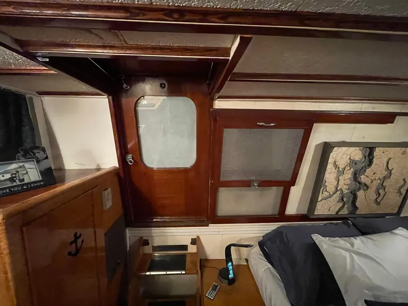 Slide: The Image of Interior of a 1951 Chris-Craft Catalina boat with wooden paneling and nautical decor. - 16