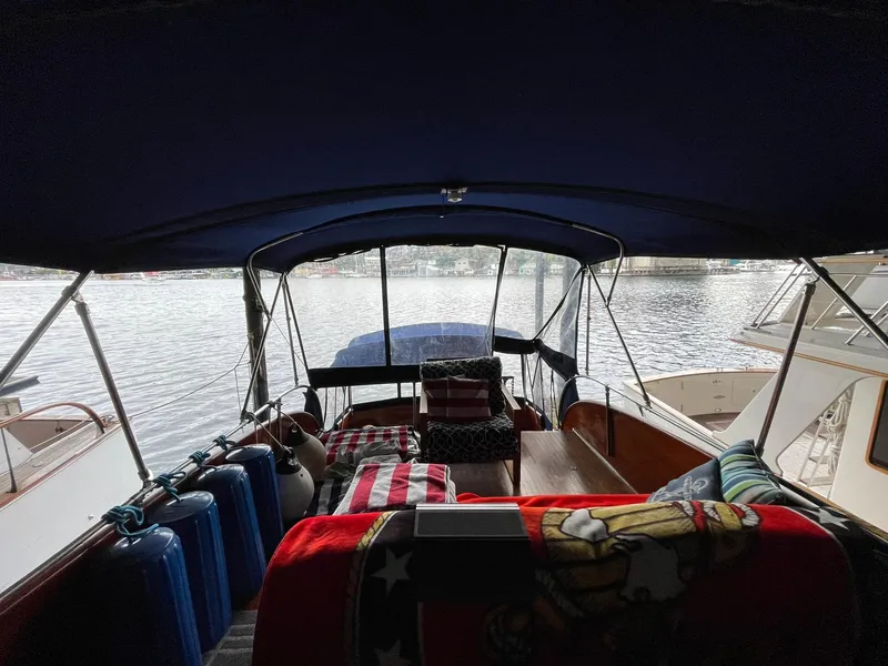 Slide: The Image of 1951 Chris-Craft Catalina boat interior with canopy, docked by the water. - 30