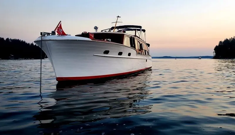 Slide: The Image of 1951 Chris-Craft Catalina boat on calm water at sunset, showcasing classic design. - 38