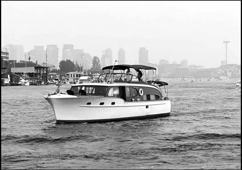 Slide: The Image of 1951 Chris-Craft Catalina boat cruising on water with city skyline in background. - 39