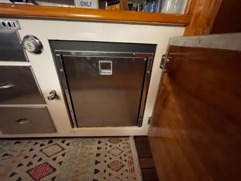 Slide: The Image of 1951 Chris-Craft Catalina interior with stainless steel appliance and wooden cabinetry. - 5